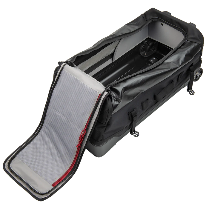 This side-top view reveals the wide-open main compartment of the Road Less Traveled 100L Duffel Bag, showcasing the spacious interior and the reflective, light-colored lining that helps you quickly locate dark gear in low light.