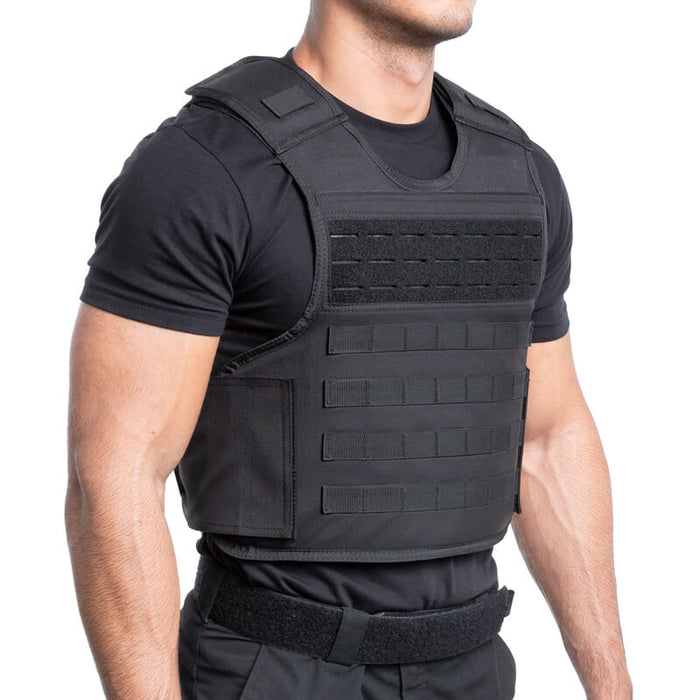 A left isometric view of the black safe life defense tactical carrier on a model, showing the side adjustment straps, shoulder weight distribution, and the low-profile fit of the vest during active use.