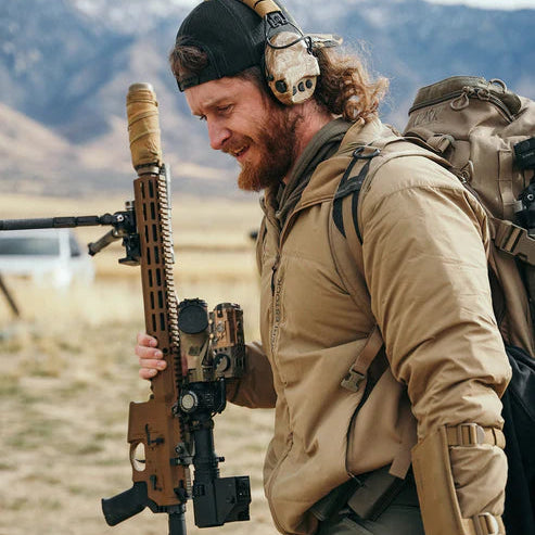 Shooter carrying an Eberlestock Switchblade pack while wearing the Alturas Hooded Jacket in Dry Earth.