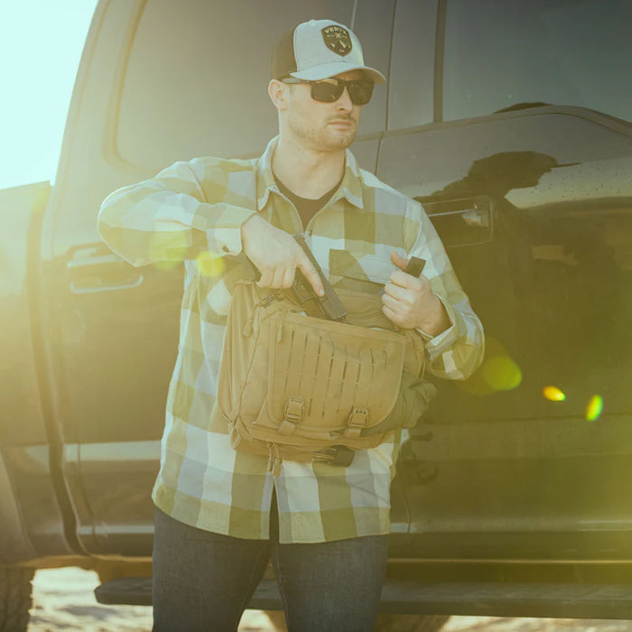 Shooter drawing a pistol from the CCW compartment of the Vertx Siege.