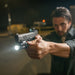 A focused shot of a shooter holding a Sig Sauer P365XL equipped with a SureFire XC3 Sub Handgun WeaponLight, demonstrating how the compact light fits perfectly flush with the extended slide and grip for a streamlined concealed carry setup.