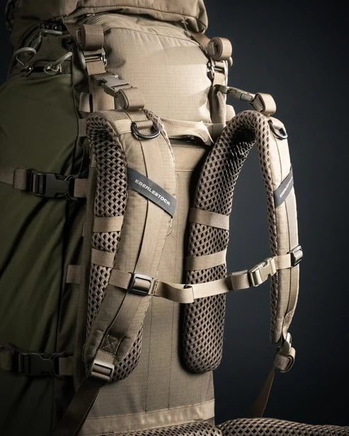 A side angled view of the rear of the Eberlestock Brute 4500 Hiking Backpack, showcasing the high-performance contour shoulder straps that provide specialized airflow and comfort during multi-day expeditions.