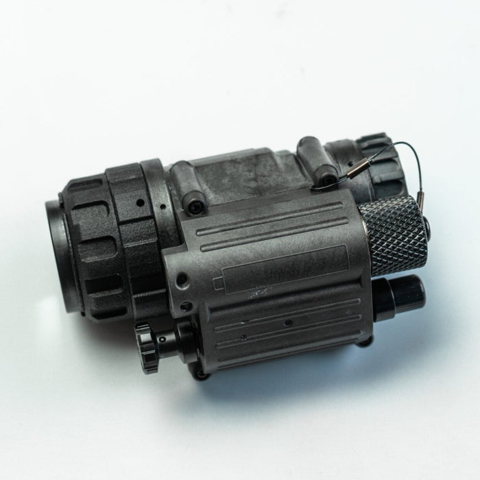 A detailed left-side profile view of the l3harris pvs 14 monocular housing, showcasing its rugged construction and side mounting interface points.