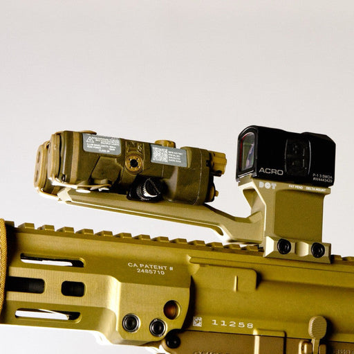 A side profile view of a short-barreled rifle equipped with a flat dark earth DOTronic Delta ACRO Mount. The complete tactical setup includes an attached Aimpoint ACRO P-1 optic and a matching FDE Diving Board Attachment holding a forward-mounted laser rangefinder.