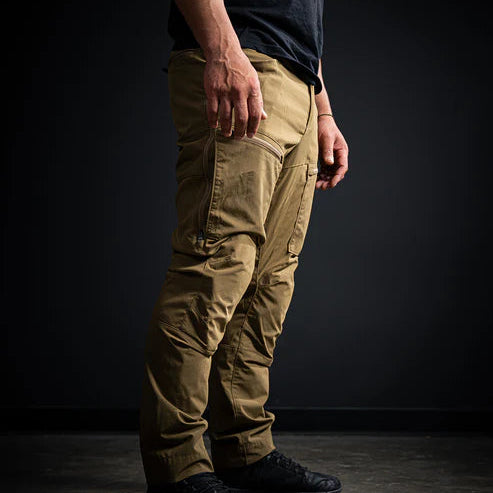 A side profile view of the Coyote Brown Deadwood Pants, highlighting the two-way thigh vent zippers designed to regulate temperature during active hunts.