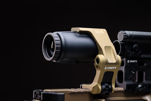 A side profile view of the Unity Tactical FAST 4X Mag securely attached to a FAST FTC OMNI mount, highlighting the robust mechanical interface and compact design.