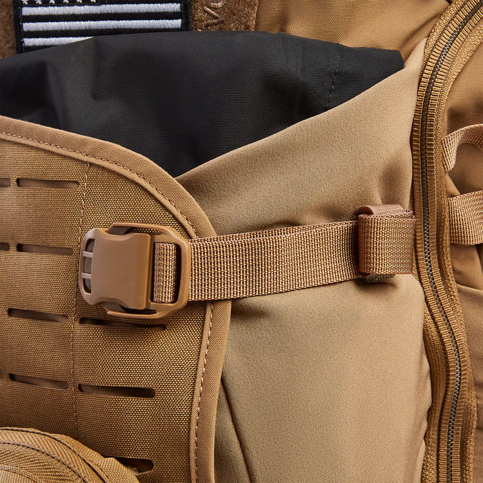 
Zoomed-in view of the Siege 35L Pack in Coyote Brown, showing the expandable front pocket fully extended to provide extra carry capacity for bulky mission gear like helmets or jackets.