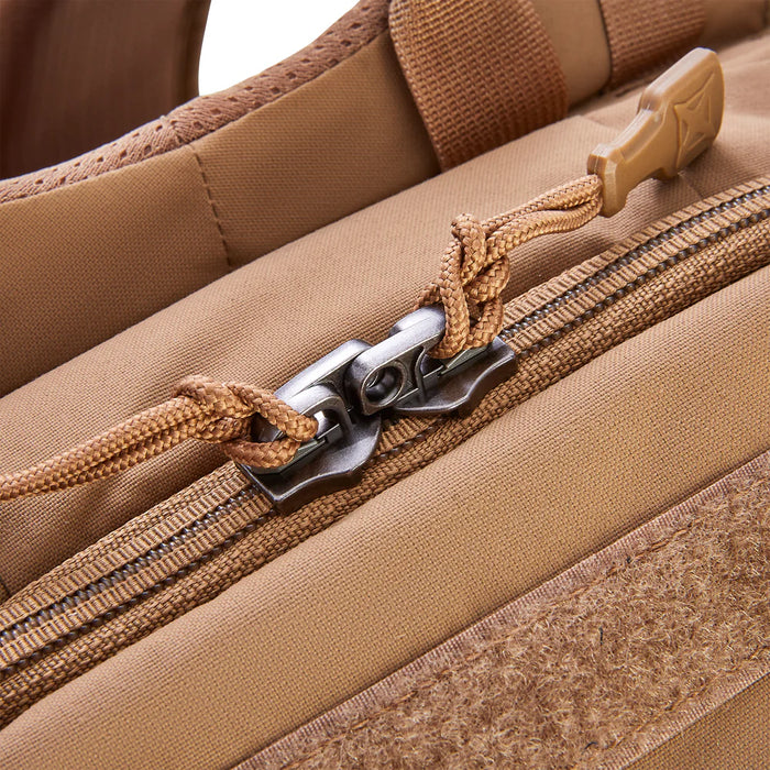 Close-up detail of the heavy-duty YKK locking zippers on the Siege 35L Pack, designed to keep gear inside the main and EDC compartments secure during transport.