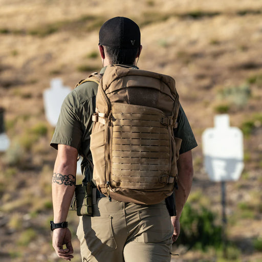 A shooter on the range wearing the Siege 35L Tactical Backpack, demonstrating its stability and secure fit during live-fire exercises.