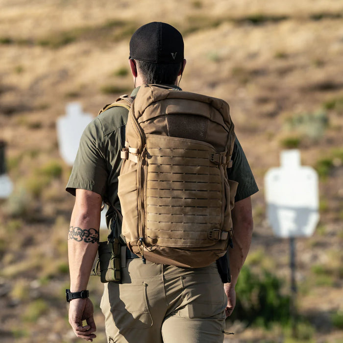 A shooter on the range wearing the Siege 35L Tactical Backpack, demonstrating its stability and secure fit during live-fire exercises.