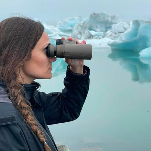 A woman looking through the Sig ZULU8 HDX binoculars