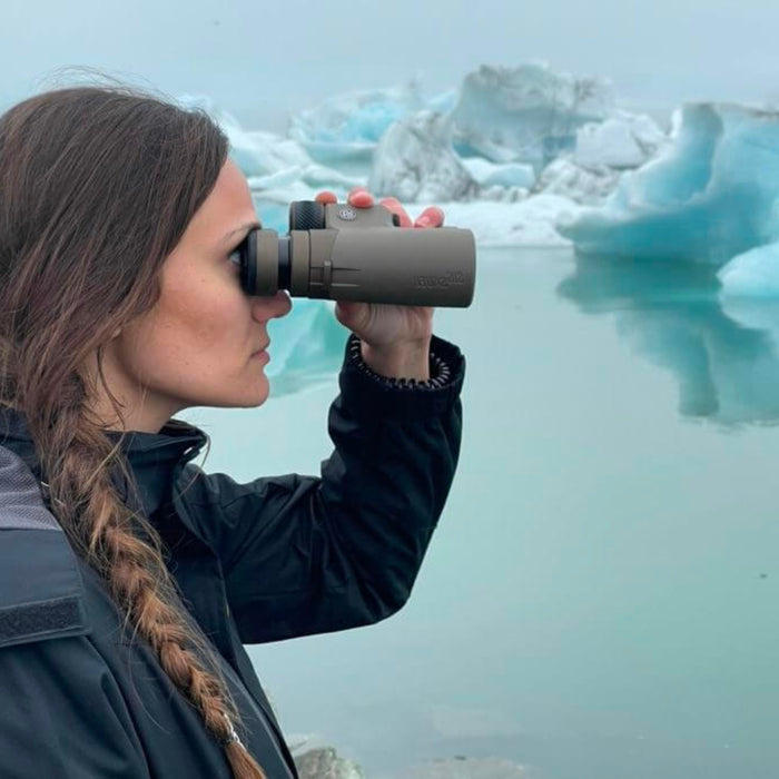 A woman looking through the Sig ZULU8 HDX binoculars