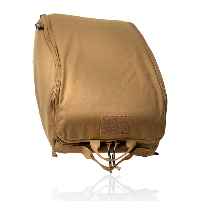 A closed, solid coyote brown ballistic helmet bag constructed with durable fabric, a heavy-duty zipper, and a lower velcro attachment point for unit identification patches.