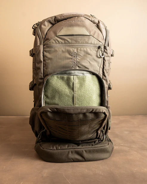 A frontal shot of the Spectre Pack in Coyote Brown with the outer pouch open, demonstrating how the specialized organization panel is ideal for mounting external pouches and accessing small gear.