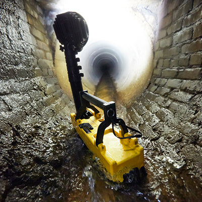 Streamlight Portable Scene Light illuminating a sewer tunnel for underground maintenance