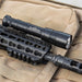 surefire-m640dft-pro-turbo-series-6-volt-dual-fuel-scout-light-pro-weaponlight-black-mounted-on-rifle-on-top-of-a-tactical-pack-with-molle