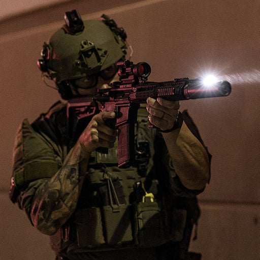 surefire-m640dft-pro-turbo-series-6-volt-dual-fuel-scout-light-pro-weaponlight-black-mounted-on-rifles-operative-aiming-at-a-target-