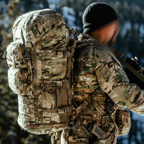 A tactical operator wearing a full MultiCam uniform is seen carrying the Eberlestock Mission Ruck 5 Day Pack in a matching MultiCam pattern during a field exercise.