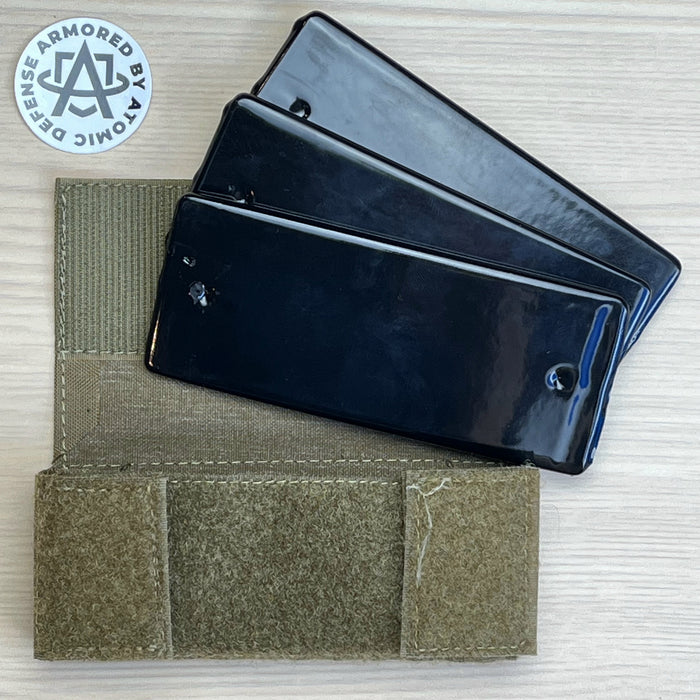 A detailed view of a Ranger Green team wendy exfil counterweight kit with the lead weights removed from the pouch to show the three-slot organization and the heavy-duty coated construction of the 1.5 lb balancing system.