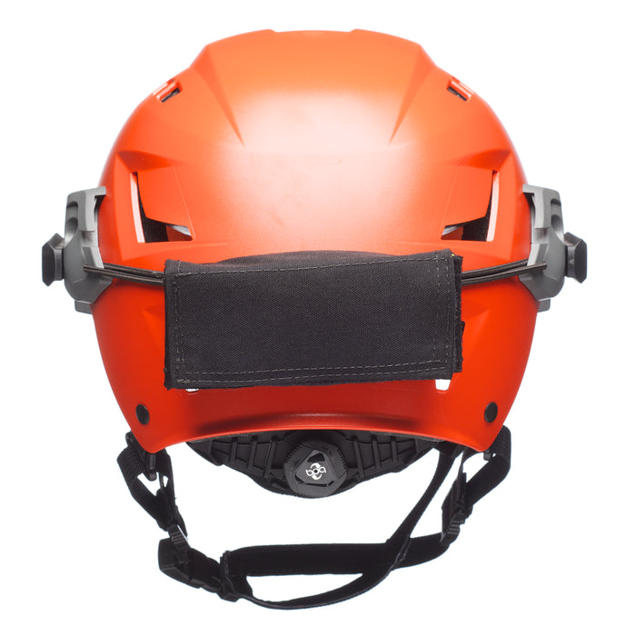 A rear view of the black Team Wendy EXFIL / EPIC Counterweight Kit securely mounted on an orange SAR helmet, illustrating how the pouch balances the headborne system for search and rescue operations.