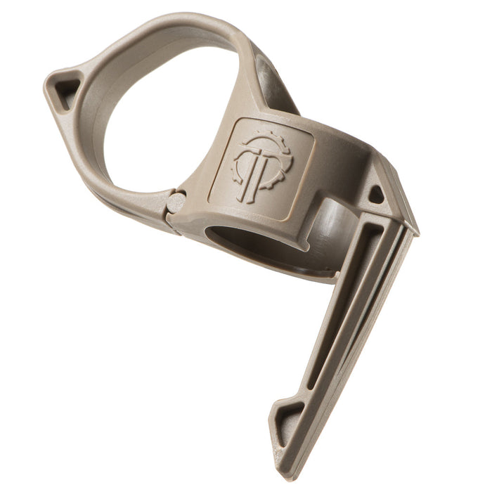 an image of the thyrm switchback 2.0 pocket clip in the color tan where the item itself is situated int he middle of the image and is tilted to the left; there is a thyrm logo branded in the middle of the item and on its right is the clip's ringer ring and on the left which is the longer part of the item is the pocket clip feature of the accessory.