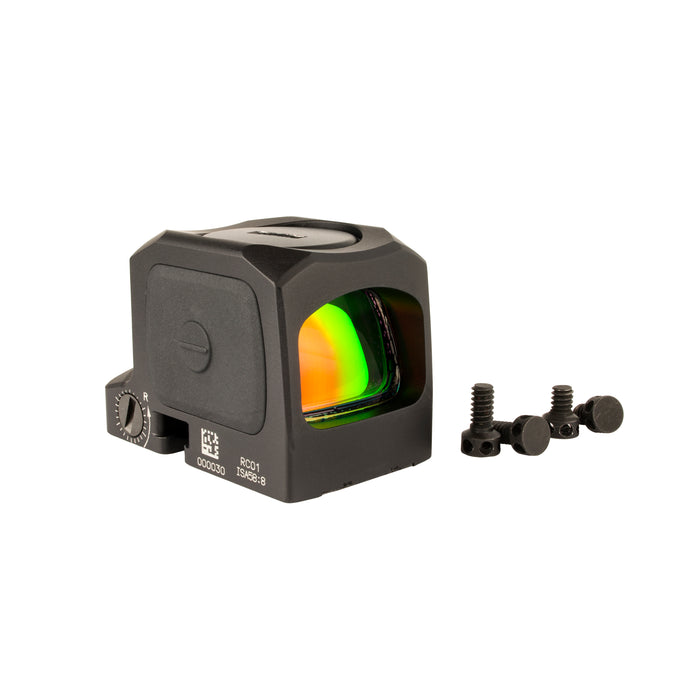 an image showing an isometric right side view of the Trijicon RCR closed emitter red dot sight against a plain white background with the left side panel features a prominent circular Trijicon logo, and above it and the top of the body holds the battery cap with a coin slot and right beside are the screws that come for its mounting