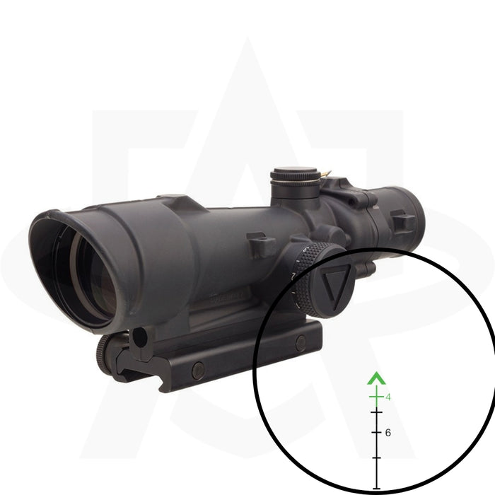 A close-up view through the lens of a trijicon acog 3.5x35 led showing the bright green chevron reticle with integrated bullet drop compensation marks