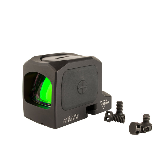 an image showing an isometric left side view of the Trijicon RCR closed emitter red dot sight against a plain white background with the left side panel features a prominent circular Trijicon logo, and above it and the top of the body holds the battery cap with a coin slot and right beside are the screws that come for its mounting
