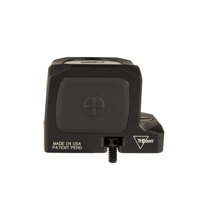 a sideview product photo of the Trijicon RCR Red Dot Sight against a plain white background and prominently featured at the front-left, reflecting a dramatic green and orange dichroic coating and showing small white laser-engraved markings are visible along the base on the right side: 'MADE IN USA PATENT PEND', with the small Trijicon 'Tri' triangle logo above it.
