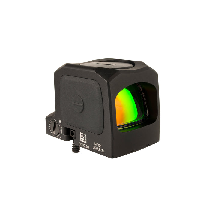 an rightside isometric product photo of the Trijicon RCR Red Dot Sight against a plain white background and prominently featured at the front-left, reflecting a dramatic green and orange dichroic coating and showing small white laser-engraved markings are visible along the base on the side saying '000030', 'RC01', and 'ISA 58:8'
