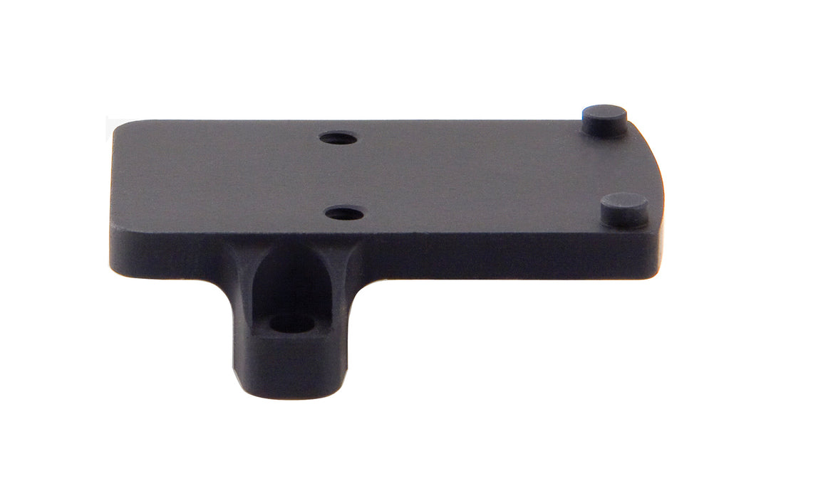 a product image of the trijicon rmr footprint mount in its backview featuring the product that small, flat, rectangular platform featuring four distinct protrusions that are two round recoil pins and two thread screw holes and in the color black and with a side screw hole to plug directly into the bottom of the optic to absorb physical force