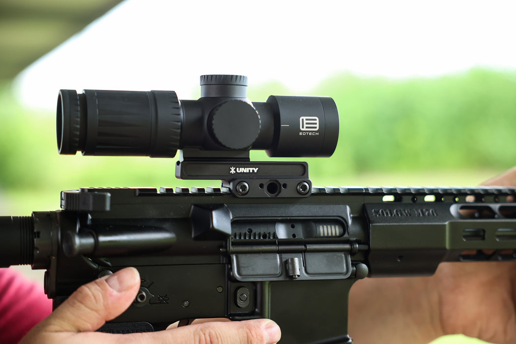 A right-side profile view of the black Unity FAST Kickr Mount for Vudu installed on an AR-15, securing a black EOTECH Vudu scope at the 1.54-inch optical centerline for a streamlined rifle setup.