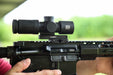 A right-side profile view of the black Unity FAST Kickr Mount for Vudu installed on an AR-15, securing a black EOTECH Vudu scope at the 1.54-inch optical centerline for a streamlined rifle setup.