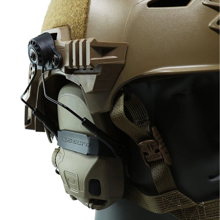 A detailed view showing the black unity tactical mark 2.0 attaching an Ops-Core AMP communication headset to the side rails of a coyote brown Team Wendy EXFIL bump helmet, providing a seamless and low-profile integration for professional headborne systems.