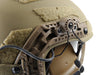 A close-up view of the coyote brown unity tactical mark securely mounting a 3M Peltor ComTac V headset to the side rails of a coyote brown Galvion Revision Caiman ballistic helmet, illustrating how the high-impact polymer body maintains a low profile.