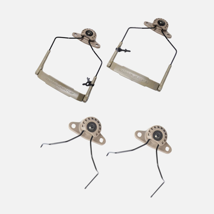 A side-by-side comparison of two coyote brown versions of the unity tactical mark kit, displaying the specific wire forms required for 3M Peltor style headsets and the Ops-Core AMP communication system. These high-impact polymer mounts attach directly to helmet rails to provide a lower profile and a more secure ear cup seal.