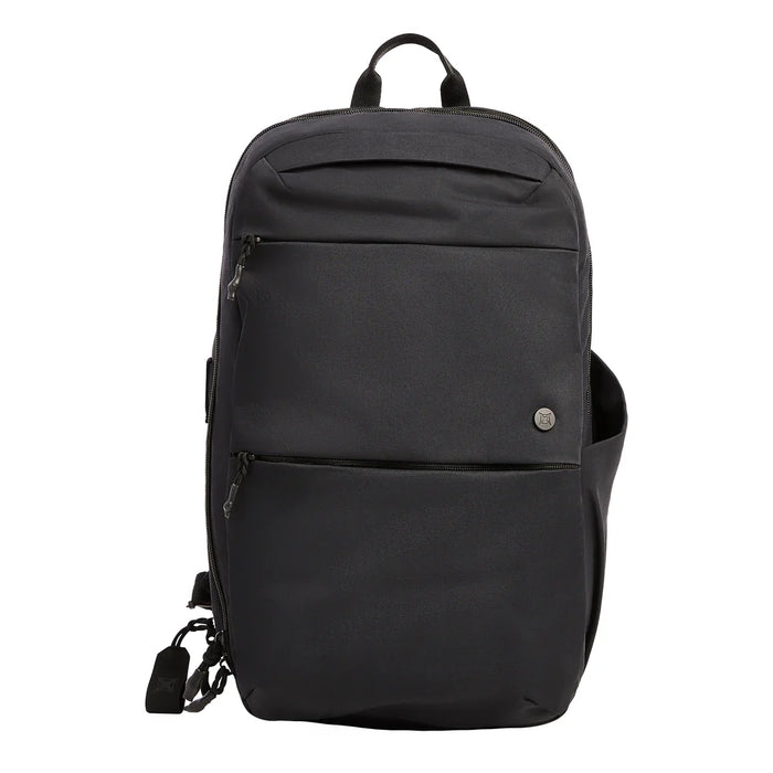 A clean frontal view of the Vertx Any Day Pack in solid black, showcasing its sleek urban profile, durable nylon construction, and two large front zippered pockets that blend into the bag for a low-profile look.
