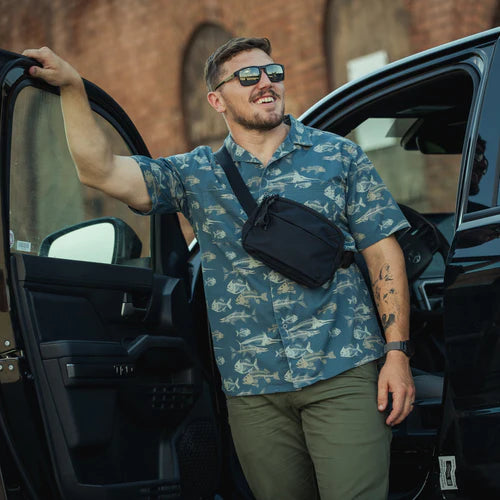 Person wearing the Vertx Dadeland CCW Shirt with a crossbody bag for everyday concealed carry