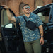 Person wearing the Vertx Dadeland CCW Shirt with a crossbody bag for everyday concealed carry
