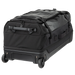 A rear photograph focuses on the bottom of the Vertx RLT 100L Duffel Roller, showing the heavy-duty molded pull handle in the foreground and the rugged, shock-absorbing 84mm wheel system built for rough terrain.