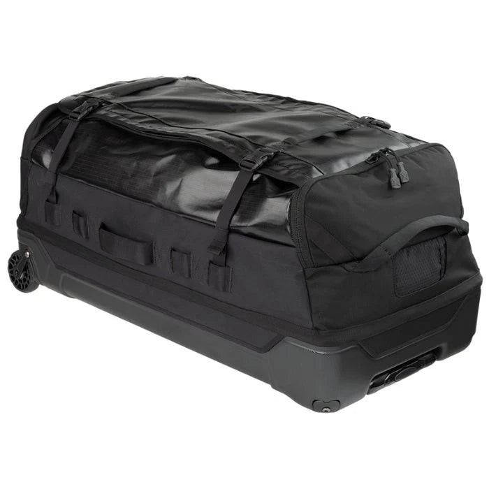 A side angled view shows the Vertx RLT 100L Roller Duffel Bag highlighting its sturdy aluminum retracting handle and the translucent mono-honey mesh ID slot positioned clearly in the foreground.