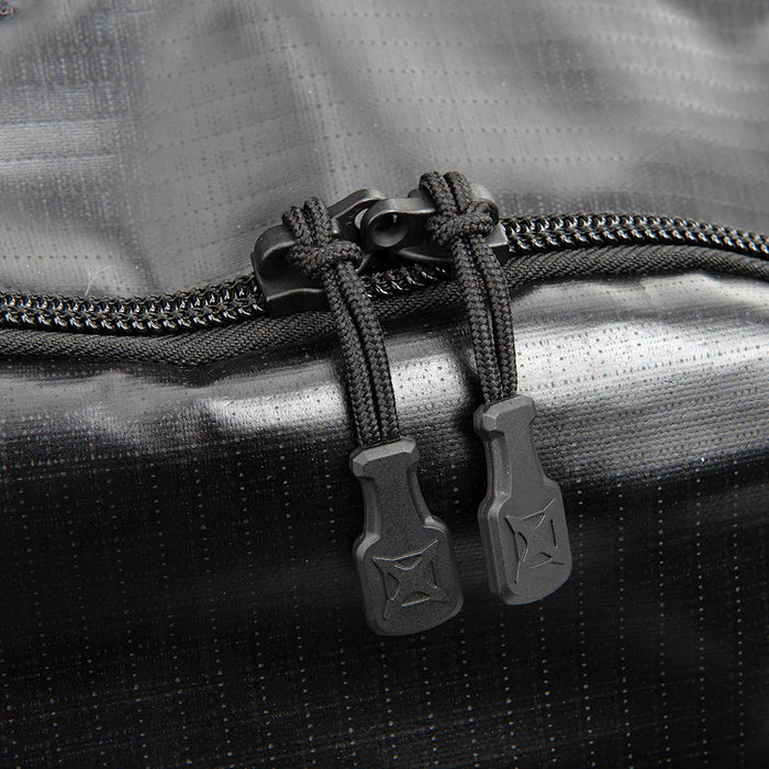 This extreme close-up of the Vertx RLT 80L Roller Duffel features the heavy-duty YKK zippers, highlighting their rugged construction and oversized pulls designed for reliable operation and easy access under heavy use.
