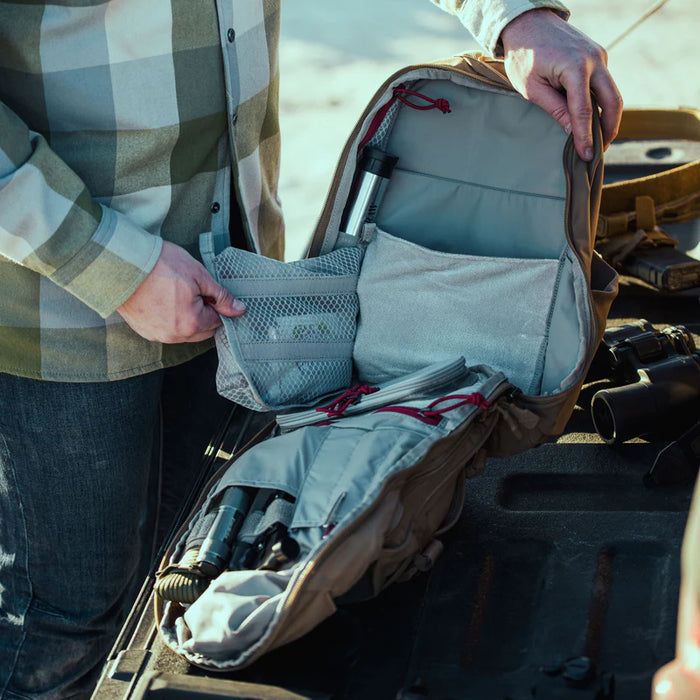 Interior view of the Vertx Siege 15L Tactical Sling Bag loaded with multiple accessories and tactical gear.