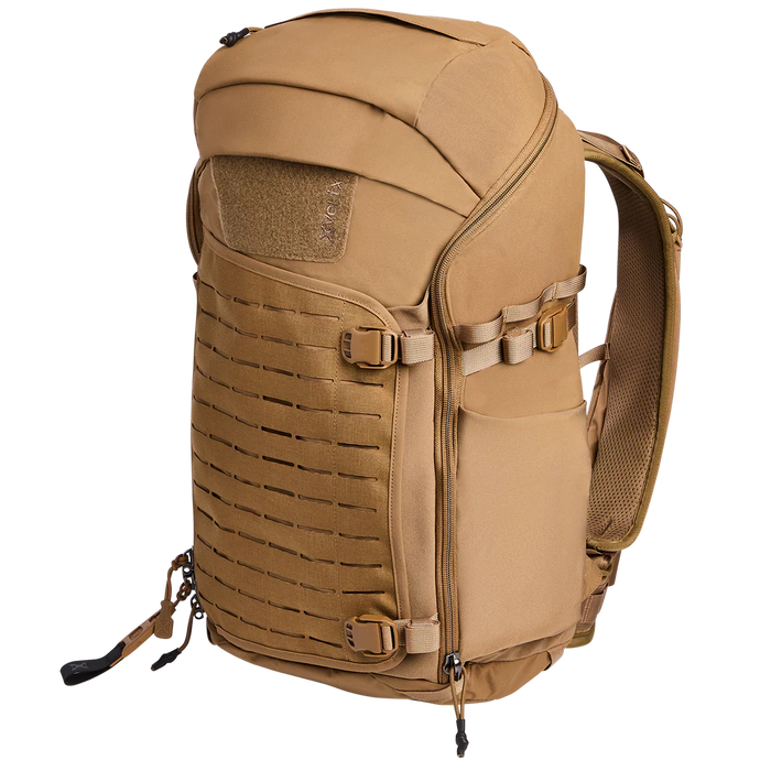 Side-angled view of the Vertx Siege 35L Tactical Backpack in Coyote, displaying its rugged profile and accessible side pockets.