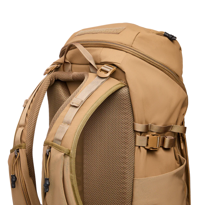 Upper rear shot of the Vertx Siege 35L, highlighting the side compression straps in the foreground designed to secure large water bottles and additional gear.