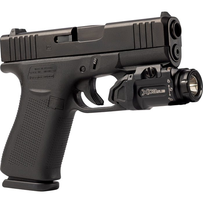 An isometric view from the right side of the XC3-SUB-A mounted on a Glock 43X, showing the flush fit of the light's bezel with the muzzle and the easy access to the right-side activation switch.